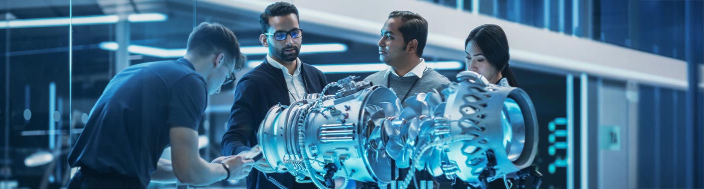 diverse team of engineers working on a turbine engine